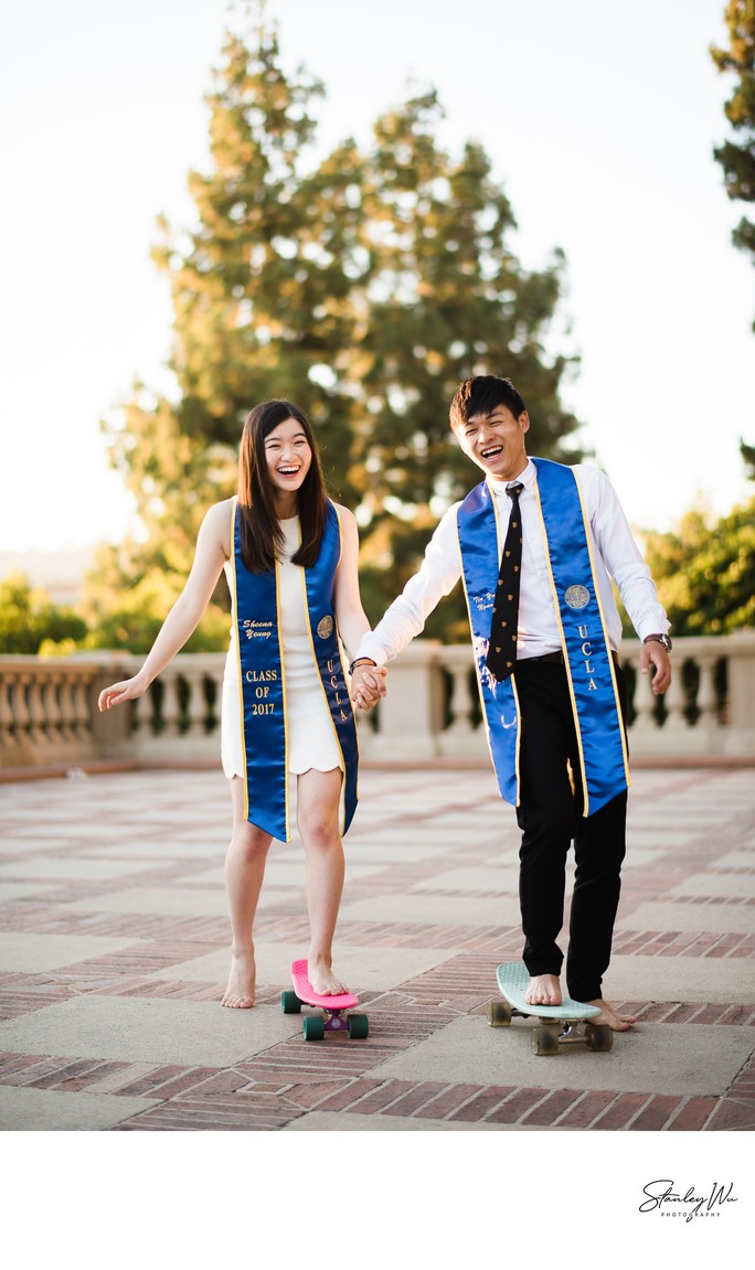 Creative Couple's Grad Portrait With Skateboards Creative Couple's Grad Portrait With Skateboards
